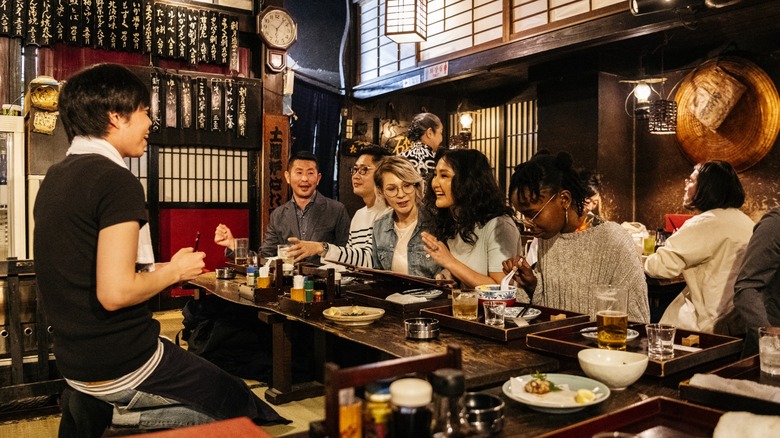 Izakaya waiter with customers