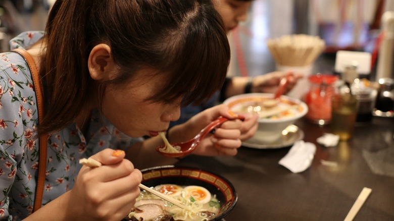 Woman eating ramen