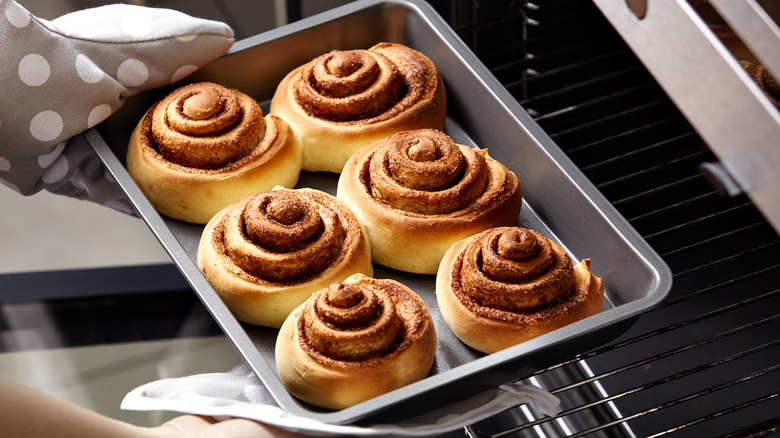 Removing cinnamon rolls from oven