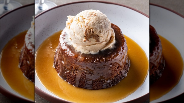 The Sticky Toffee Pudding at Hell's Kitchen caramel sauce with bowl