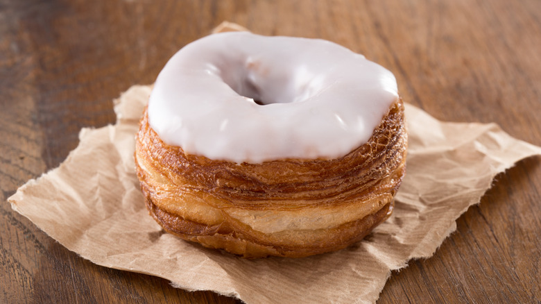 Glazed cronut on a piece of brown paper