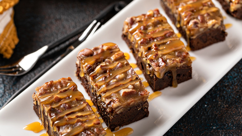 Pecan pie brownie slices on a long white plate