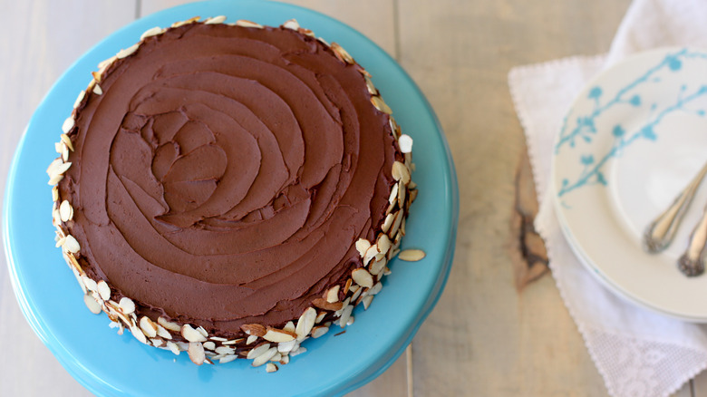 Top-down view of Reine de Saba (Queen of Sheba) cake on blue cake stand