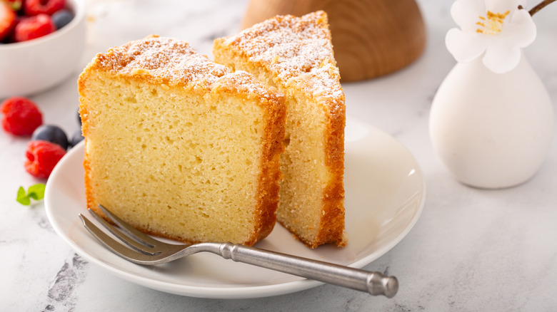 Lemon chiffon cake served on a plate on a marble table with berries