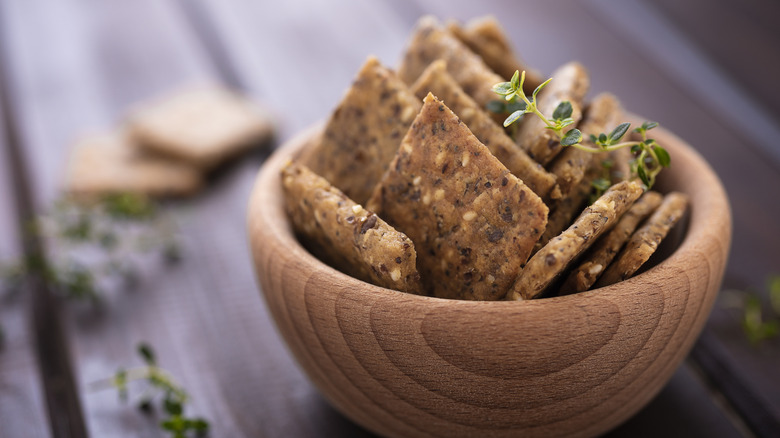 Spiced crackers in wooden bowl