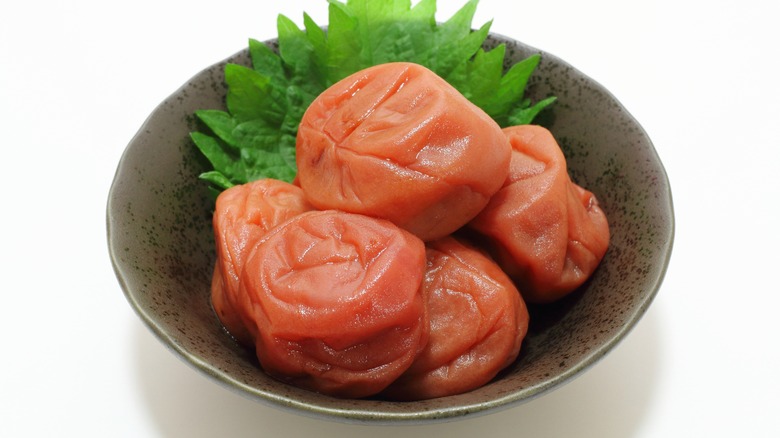 Umeboshi in a bowl against white