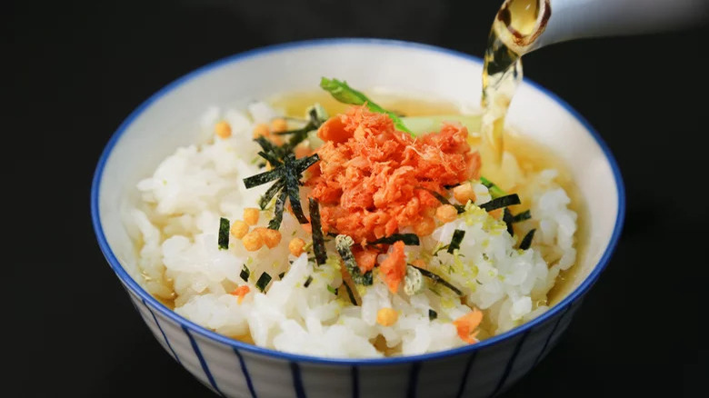 Tea being poured in bowl of chazuke