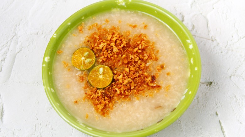 Bowl of lugaw with lime and spices