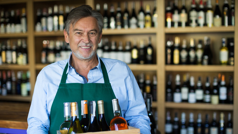 Sales clerk with wine case