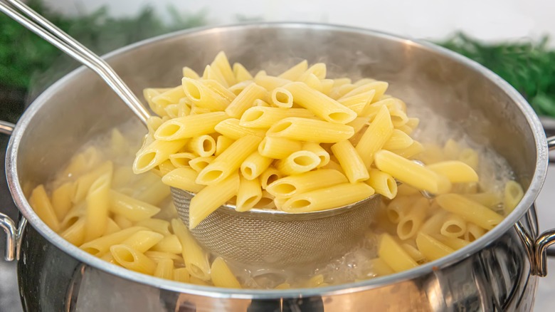 metal strainer holding boiled pasta