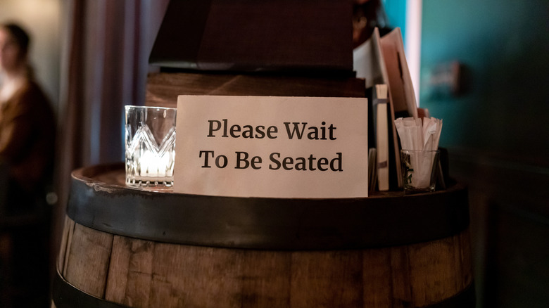 Wait to be seated sign