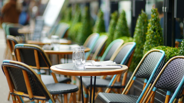 Row empty restaurant tables and chairs