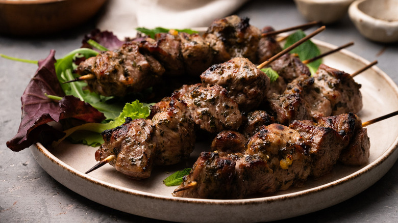 Lamb skewers on plate