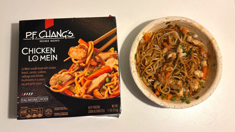 P.F. Chang's frozen chicken lo mein next to box on white table