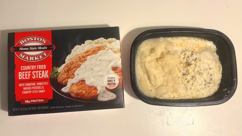 Boston Market frozen country fried beef steak next to box on white table