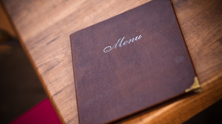 Bound restaurant menu on a wooden table