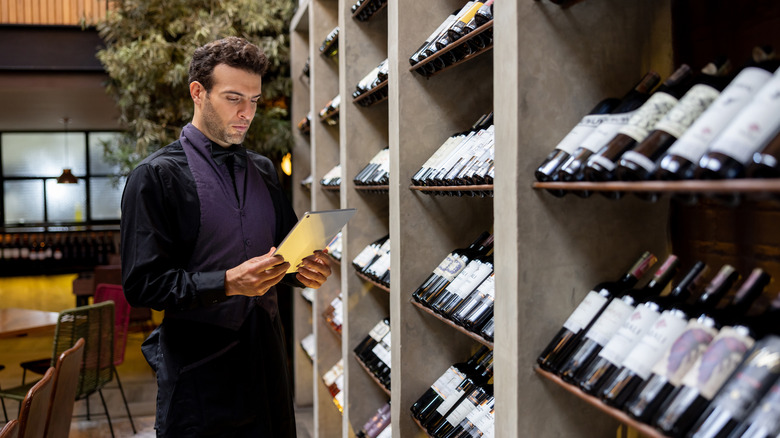 Sommelier overlooking a collection of wines