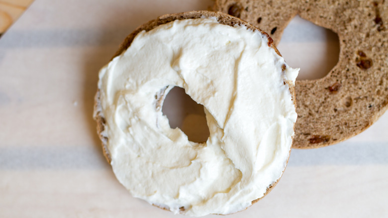 a bagel with cream cheese on top