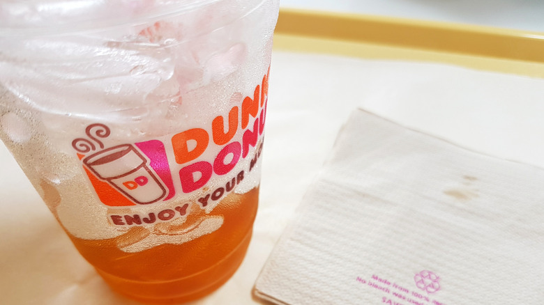 a half-full iced coffee from dunkin'
