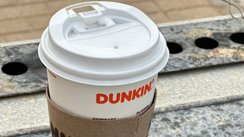 a close-up of the top of a dunkin' cup