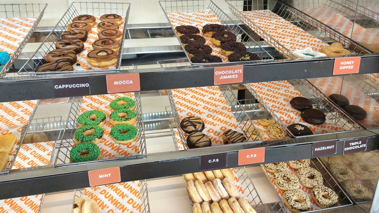 a selection of donuts on display at Dunkin'