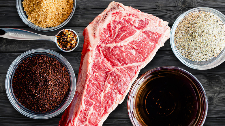 Steak surrounded by different seasonings