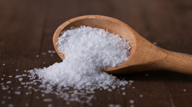 Kosher salt spilling from spoon