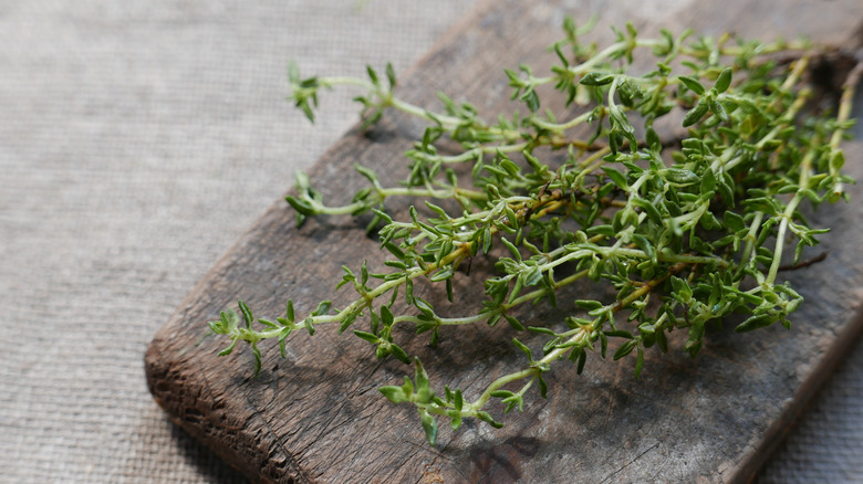 Thyme on wooden chopping board