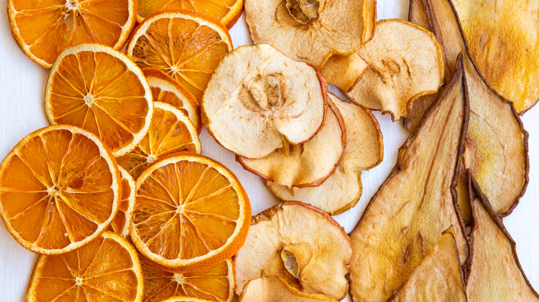 Dehydrated orange, apple, and pear slices on table