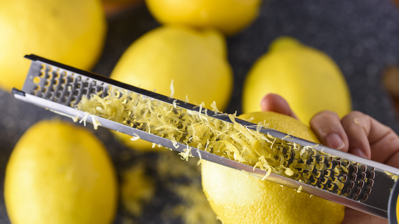 Zesting lemon with hand