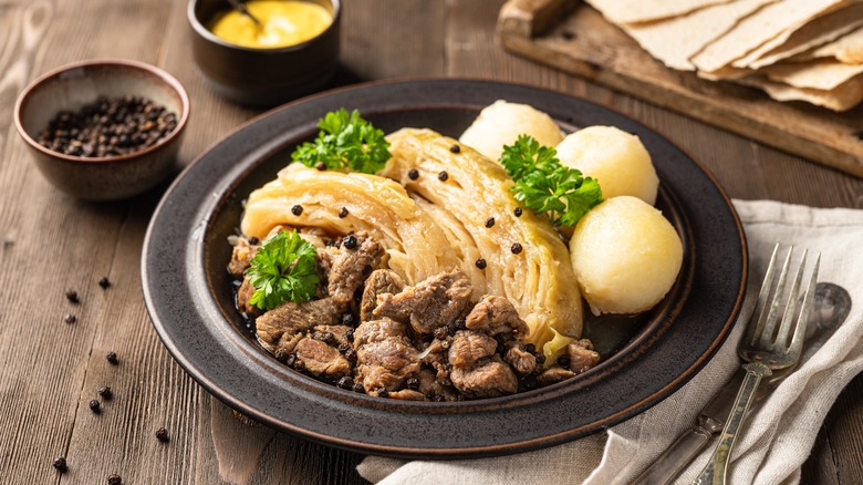 Cabbage and meat on black plate