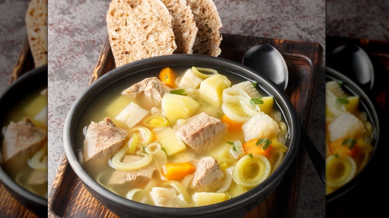 Vegetables and meat in black bowl