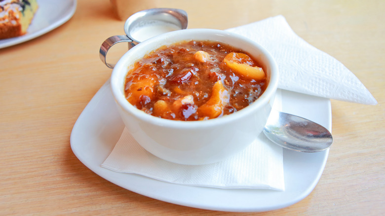 Fruit soup in white bowl on saucer