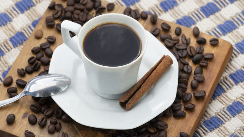 Coffee cup beans and cinnamon stick