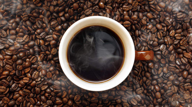 Hot coffee cup and beans