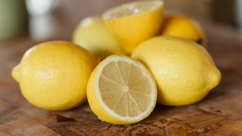 Fresh lemons on wooden cutting board