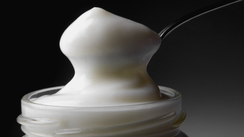 Spooning mayonnaise out of jar