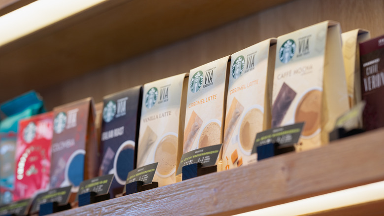 Starbucks Via coffees lined up on shelf with variety of flavors