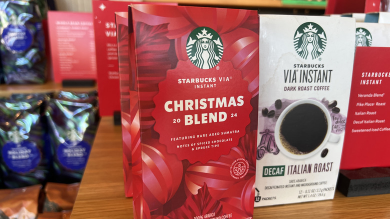 Starbucks Via coffee display featuring red holiday boxes of Via Christmas Blend