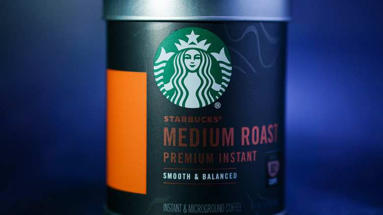 Tin of Starbucks medium roast coffee against blue background