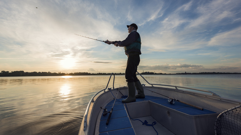 old man fishing off boat