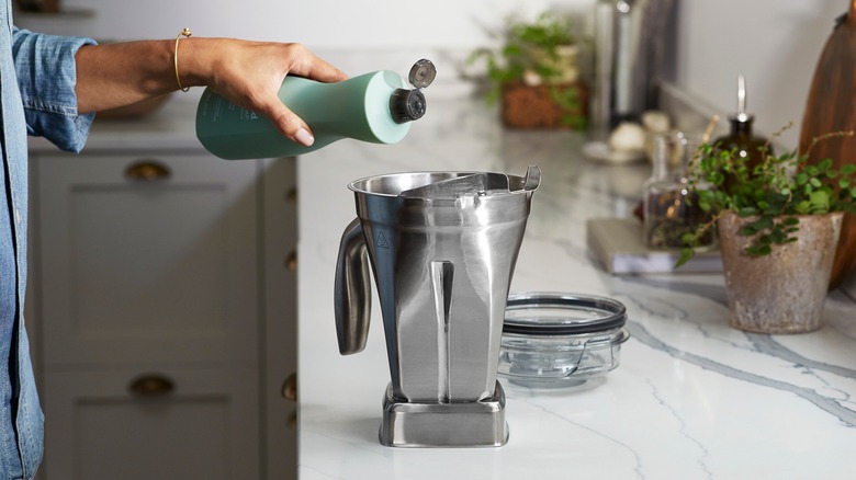 pouring soap in metal Vitamix