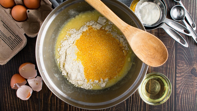 Cornbread ingredients in a large metal mixing bowl