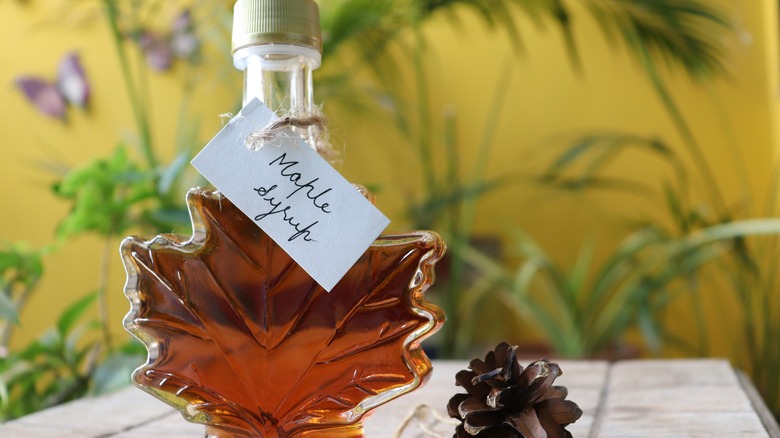 Maple syrup in glass leaf-shaped container