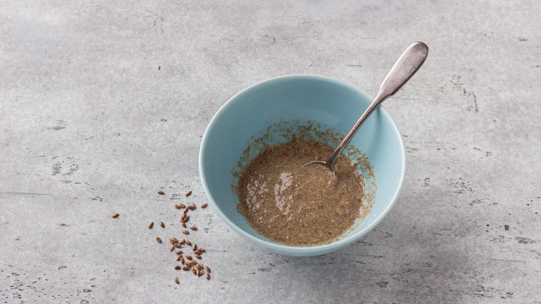 Vegan flax egg in a bowl with a metal spoon