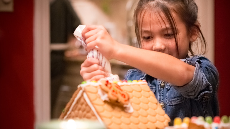 Piping icing on a gingerbread house