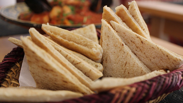 Sliced triangles of soft pita bread assembled in a basket