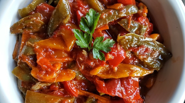 Top view of a salata matbukha the roasted tomato and pepper salad in a white bowl
