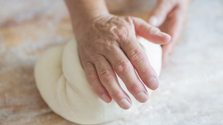 Hands kneading dough