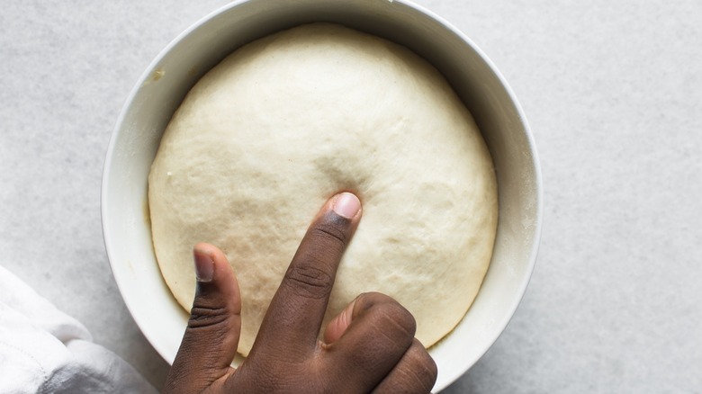 Finger poking dough ball